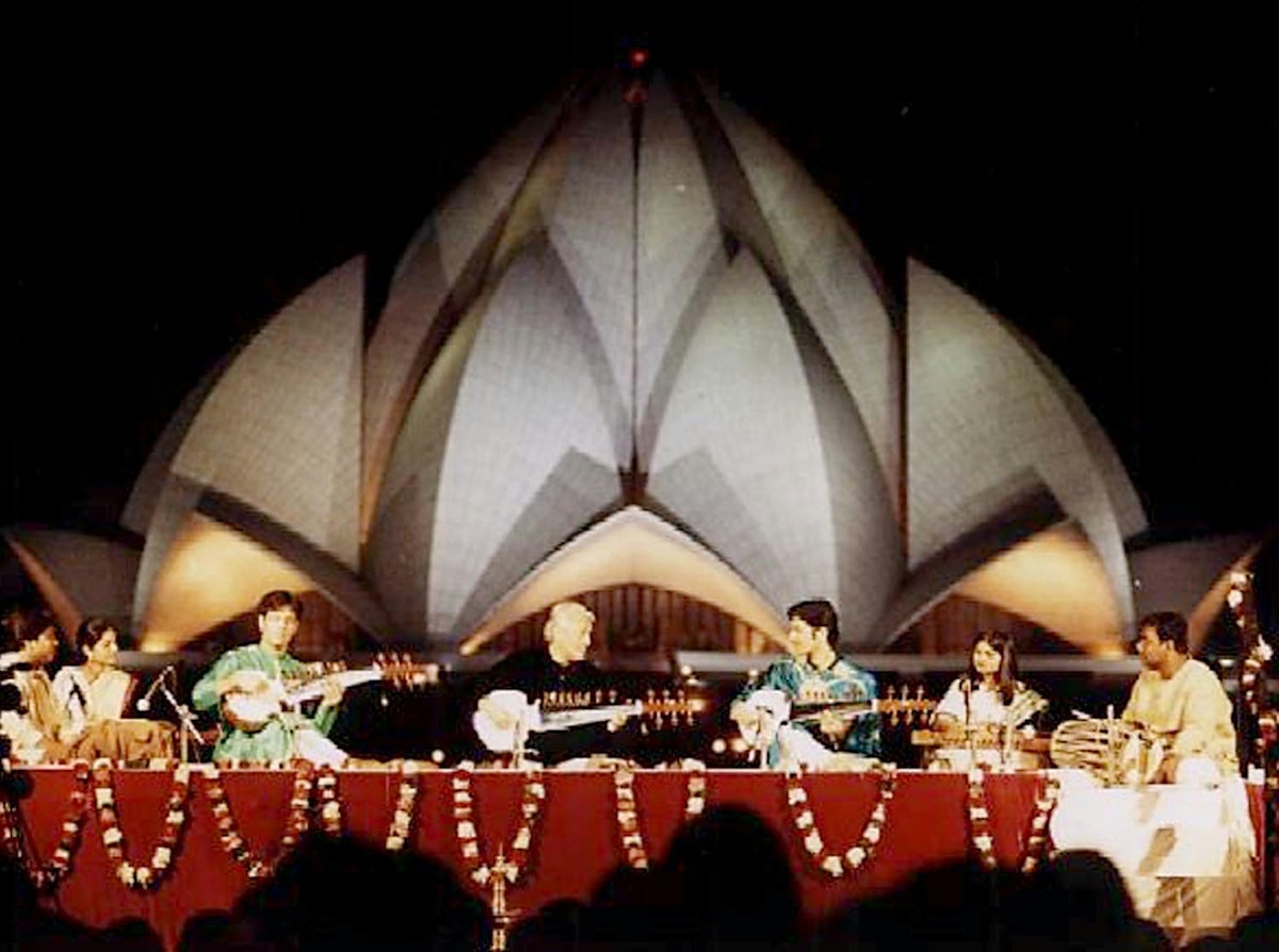The sarod maestro Amjad Ali Khan, assisted by his sons Amaan Ali Bangash and Ayaan Ali Bangash, performs in the shadow of the Baha'i House of Worship in New Delhi. The concert, entitled "Sarod for Harmony," was part of the opening program of the Colloquium on Science, Religion and Development.