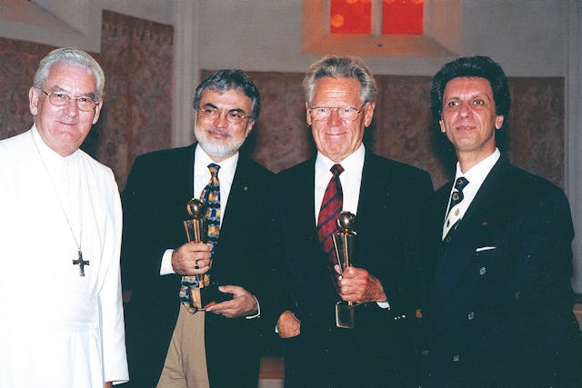 Mr. Fariborz Sahba, architect of the Lotus Temple in India, and Dr. Hans Kung, a Catholic theologian known for his work on a "global ethic," receive the GlobArt Academy 2000 award at a ceremony in the Pernegg cloister, Austria.| From left to right: Dr. Angerer, resident Abbot of Pernegg Church; Mr. Sahba; Dr. Kung; and Mr. Bijan Khadem-Missagh, well-known violinist and president of GlobArt Academy.