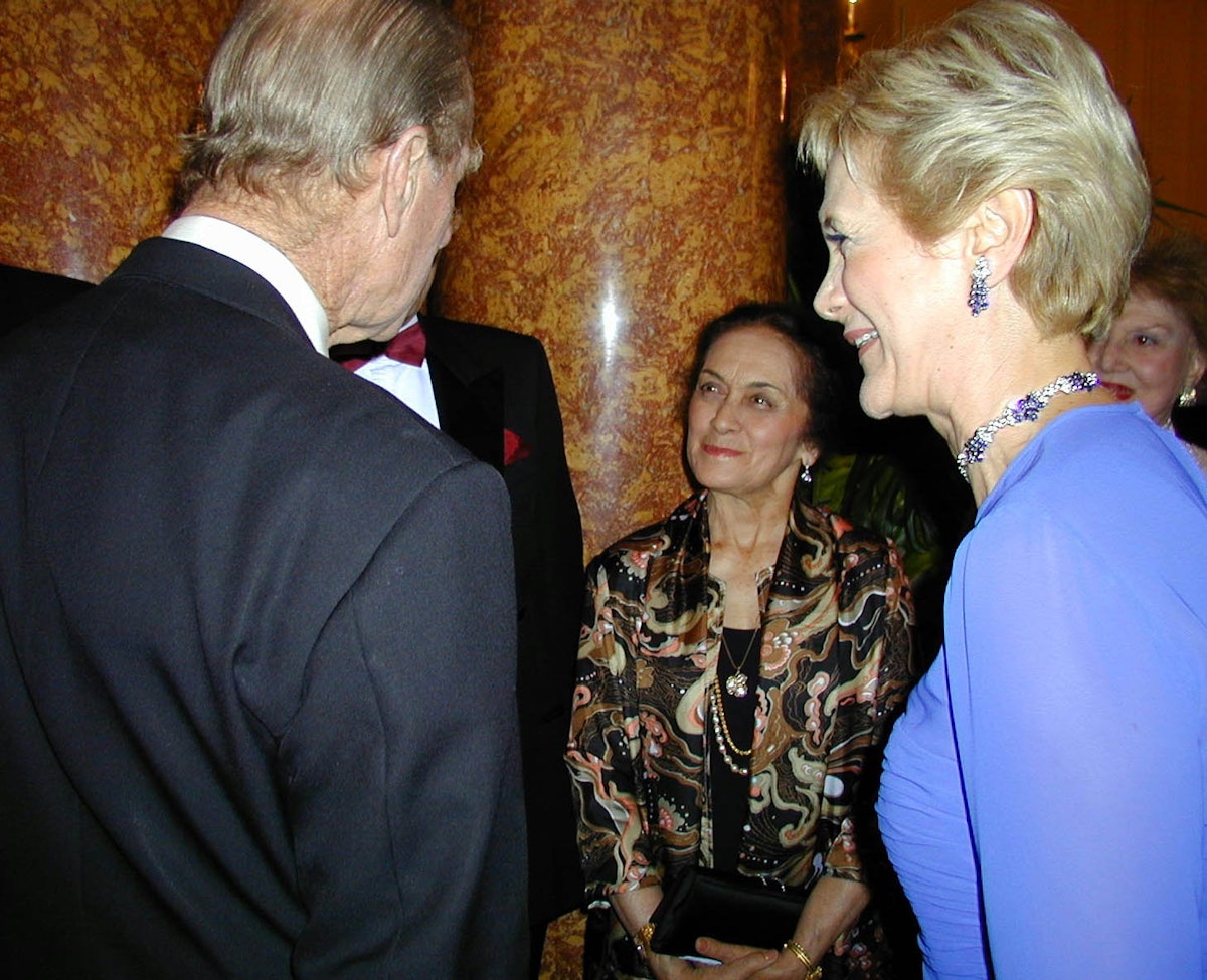 At a 15 May 2001 Arts for Nature event honoring Madame Ruhiyyih Rabbani in London, HRH Prince Philip, Duke of Edinburgh, left, talks with Ms. Violette Nahkjavani, center, in the presence of Ms. Guilda Navidi-Walker, right. Ms. Nakhjavani accompanied Madame Rabbani on her world travels and has recently written a book about her life. Ms. Navidi-Walker was convenor of the event.