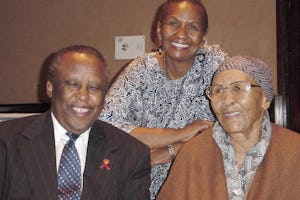 President Mogae of Botswana with two of the translators who produced selections from the Baha'i scriptures in the native Setswana language.| Left to right: President Mogae, Lally Warren, and her mother, Stella Moncho. Mrs Moncho is nearly 92 years old; she and her late husband were the first Baha'is of Botswana.