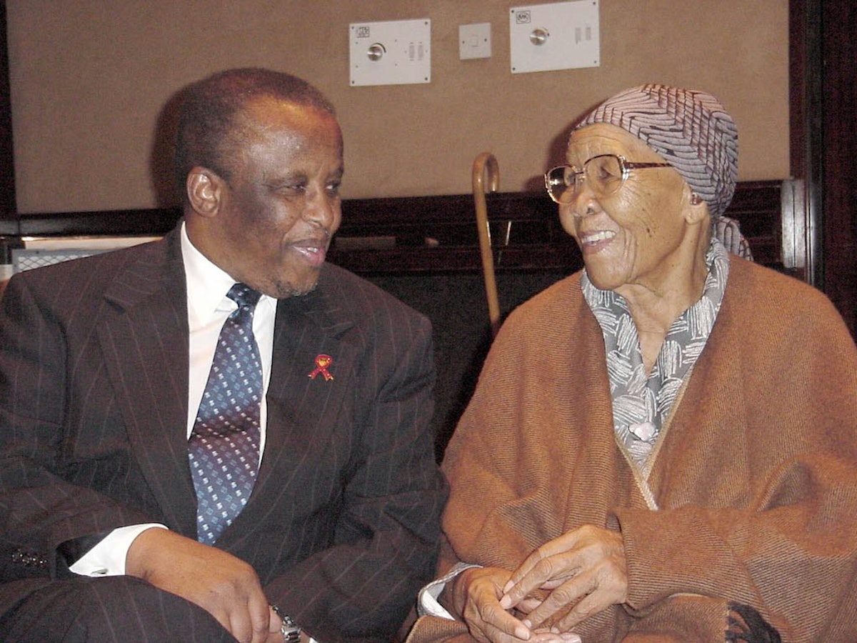 President Mogae of Botswana chats with Mrs. Stella Moncho, one of the translators who produced selections from the Baha'i scriptures in the native Setswana language. Mrs Moncho is nearly 92 years old; she and her late husband were the first Baha'is of Botswana.