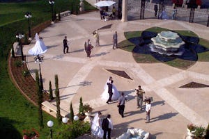Three newlywed couples have their wedding photos taken on the entrance plaza of the Baha'i Terraces on Mount Carmel, a practice that has become very common among newlyweds in Haifa.