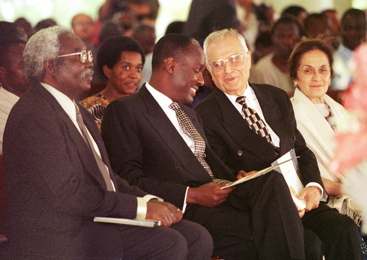 Mr. Ali Nakhjavani (third from left) speaks with Captain Michael Mukula, Uganda's State Minister for Health, at a commemoration of the 50th anniversary of the Baha’i community of Uganda held 2 August 2001 at the Baha’i House of Worship near Kampala. Mr. Nakhjavani, a member of the Universal House of Justice, was one of the six Baha’is who founded the Baha’i community in Uganda in 1951. (Photo: Ryan Lash)