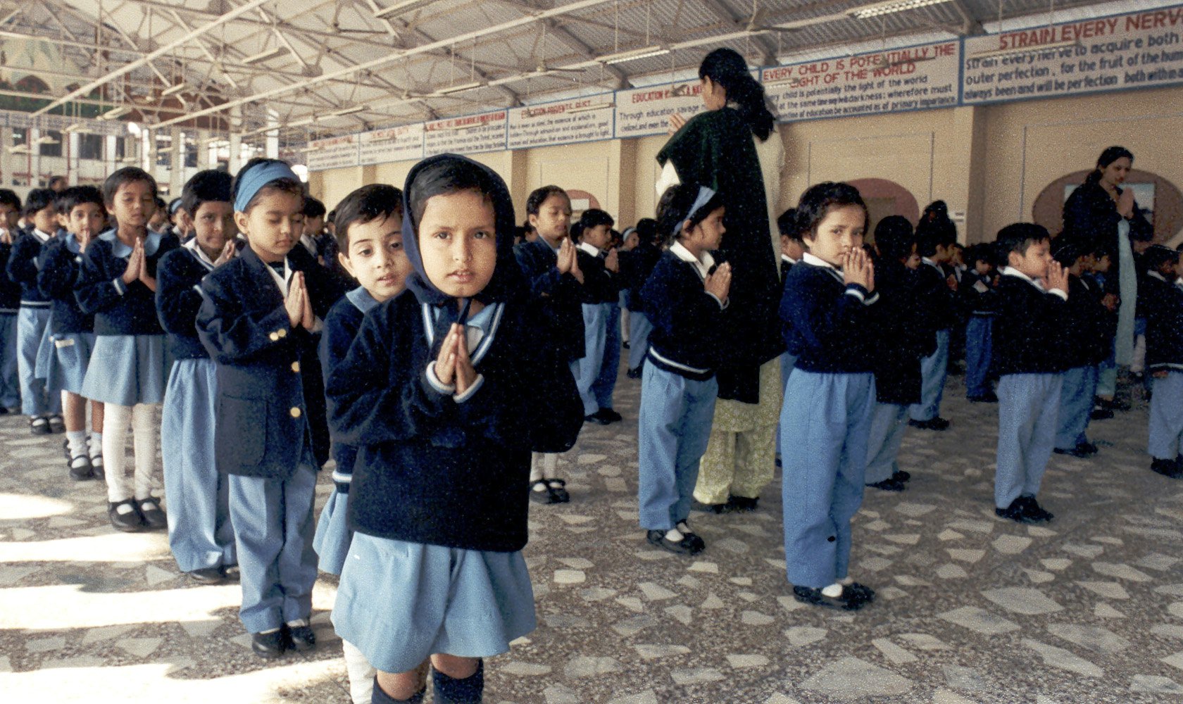 The essential principles of all religions are taught at City Montessori School, and in morning assembly each day the students read prayers from all religions.| Shown here are kindergarten students praying in the morning at the start of the day.