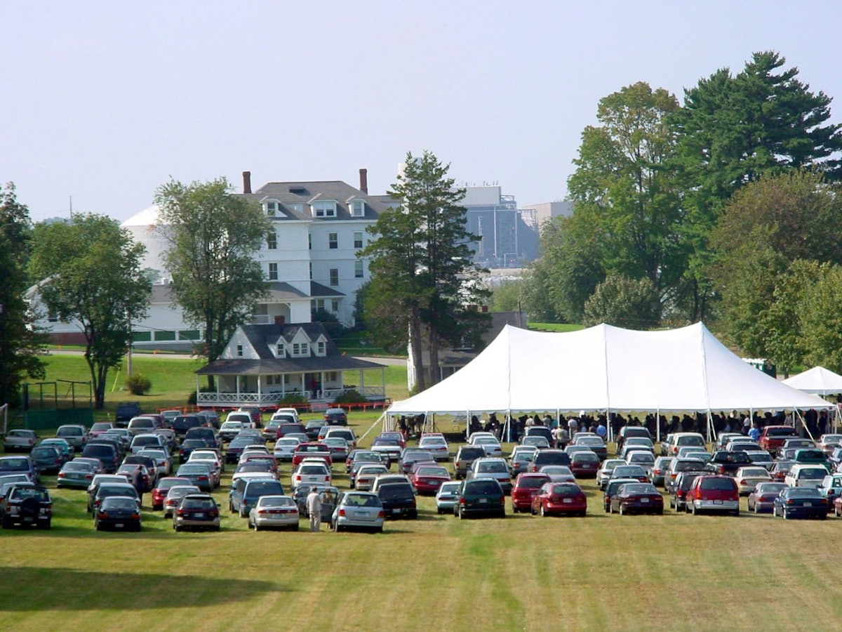 Hundreds attended the dedication of the new Harriet and Curtis Kelsey Center at Green Acre Baha'i School on 21 September 2002, which was held under a tent on the Green Acre grounds. In the background is the Sarah Farmer Inn, an historic building visited by Abdu'l-Baha.