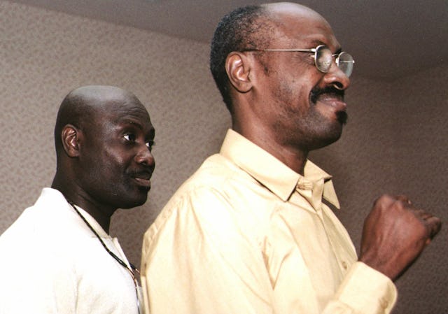 Pierre Balthazar, left, and Loulou Balthazar speaking about the Haiti "Partners in Progress" project, at the Baha'i Conference on Social and Economic Development for the Americas.