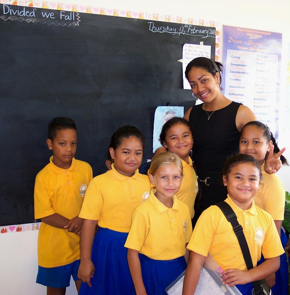 Smiles from students and their teacher at the Ocean of Light International School, which now has new buildings.