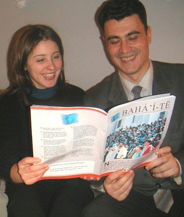 Albanian Baha’is Suela Qerreti, left, and Alfred Avdulaj examine the newly-translated magazine