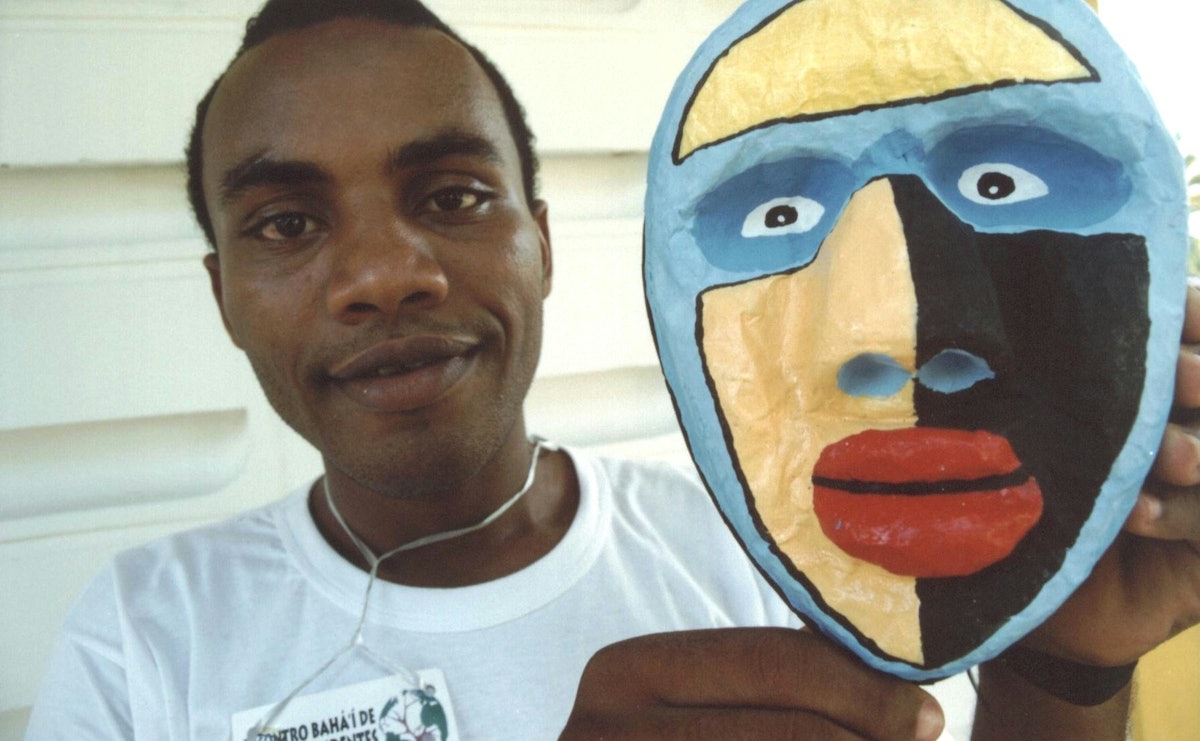 Gilson, a participant at the Afro-Descendants Gathering held in Brazil, displays his mask.