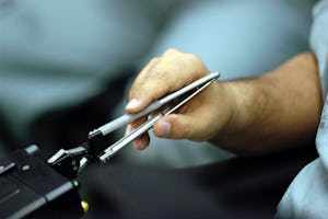A specialized instrument transmits the motions of Dr. Mehran Anvari's hands to a surgical robot some 400 kilometers away. (Courtesy St. Joseph's Healthcare)