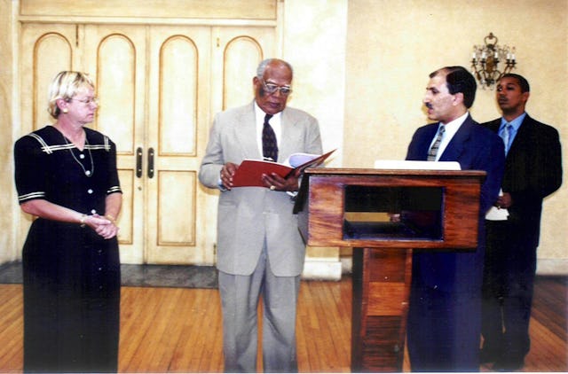 Governor General, Sir Howard Felix Hanlan Cooke, with Baha'i representatives Linda Roche (left) and Namwar Zohoori (second from right).