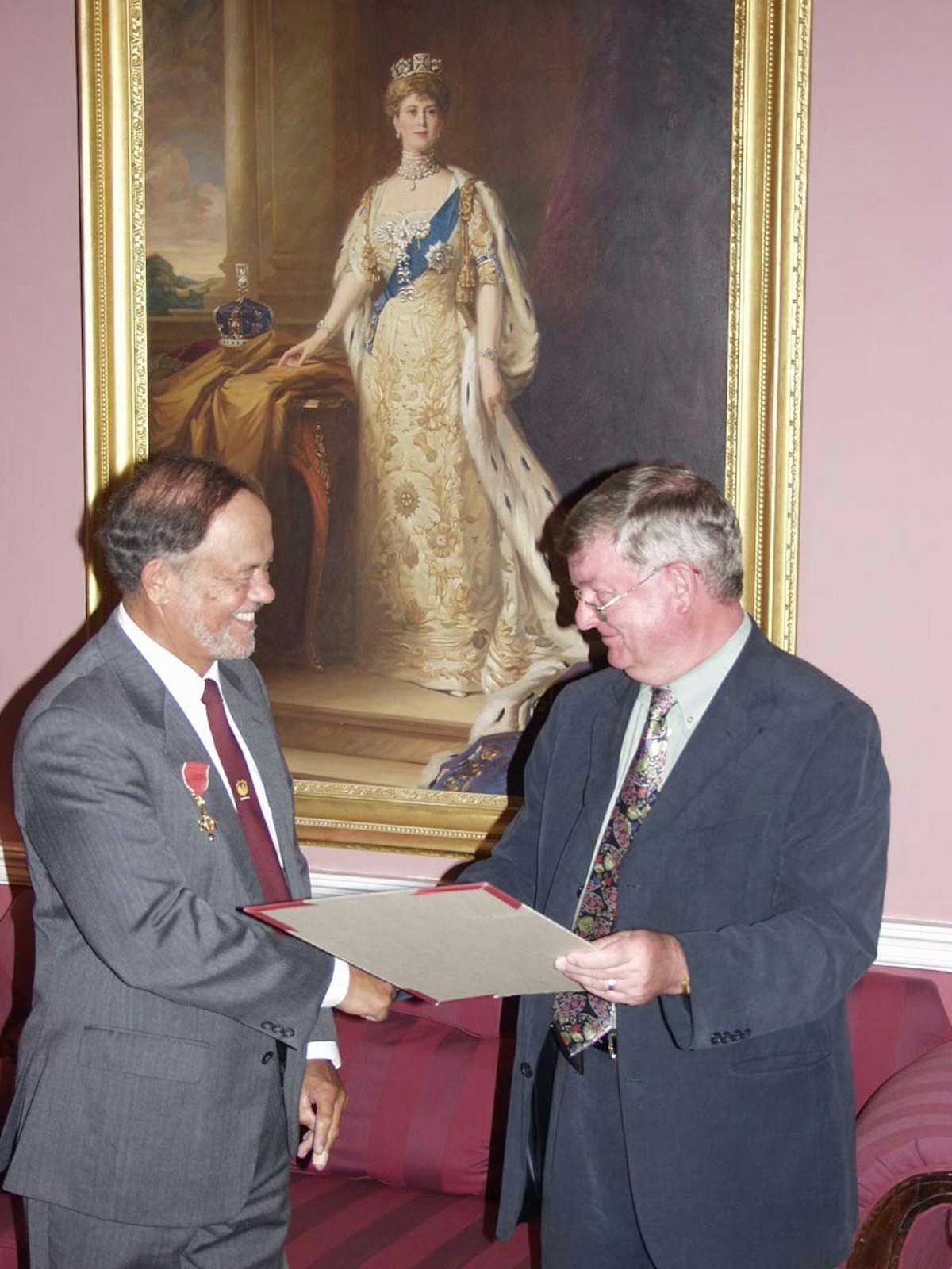 Basil George (left) receives his award from St. Helena Governor David Hollamby.