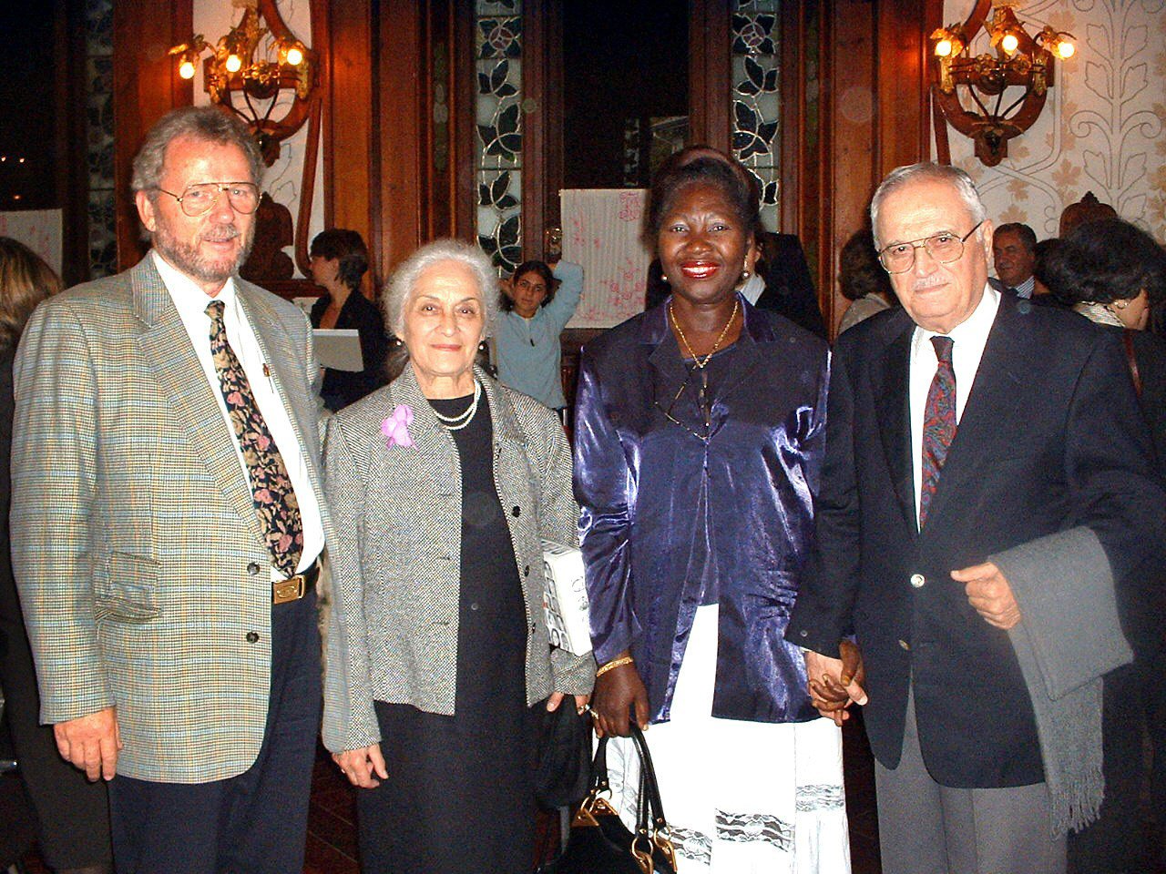Former member of the Universal House of Justice, Ali Nakhjavani (right) and his wife, Violette (second from left), with Holger and Joyce Siebers, members of the Baha'i community of Switzerland, at the centenary celebrations.