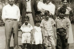 The first South African Indian to become a Baha'i was Dr. Abdul-Hak Bismillah (holding baby) in 1955. He is pictured with his wife, Joan. They are with Sombi Govind (left), Ismail Cassim and children.