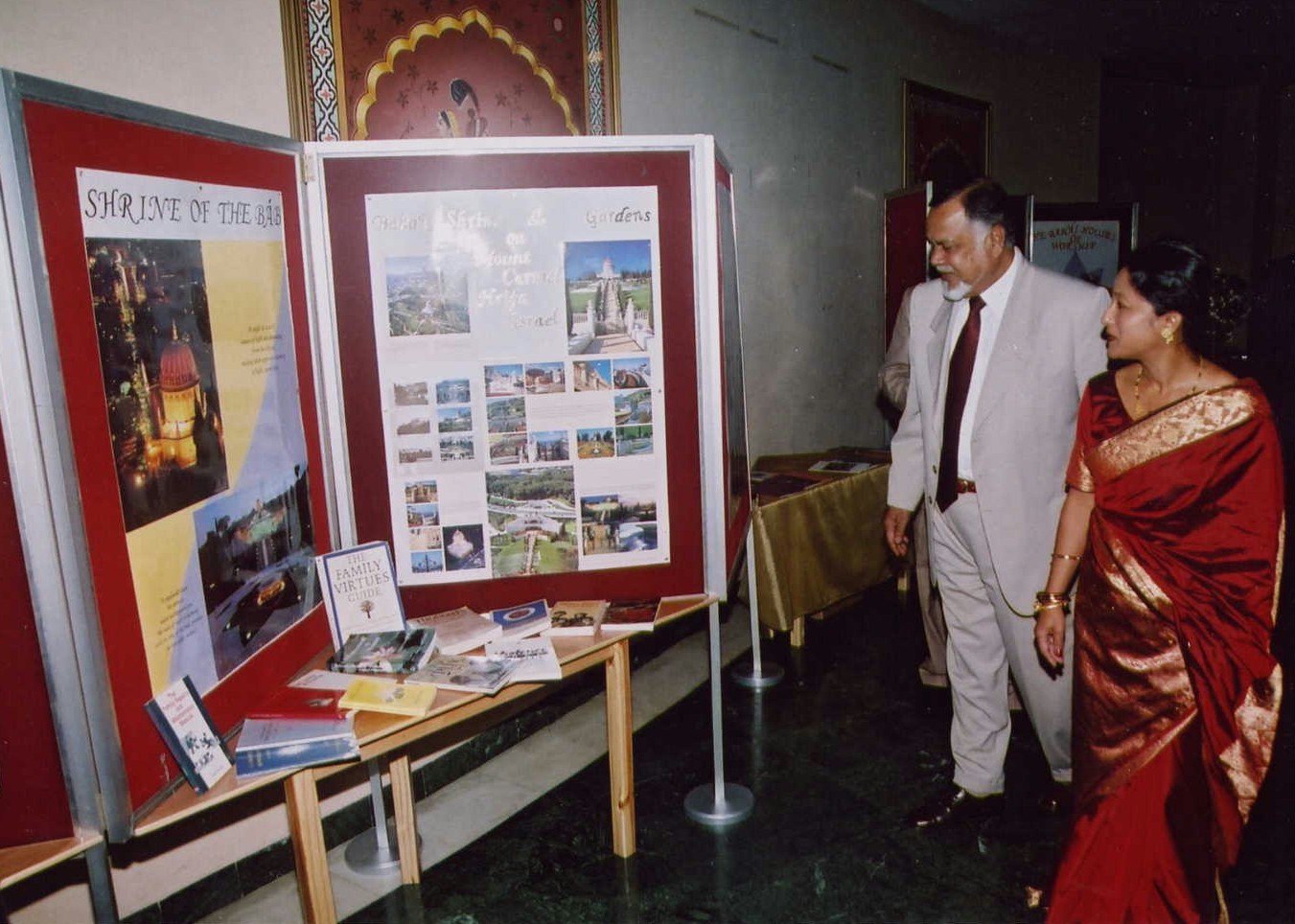 Viewing a display...Vice-President Raouf Bundhun and Baha'i guide, Chantal Servansingh.