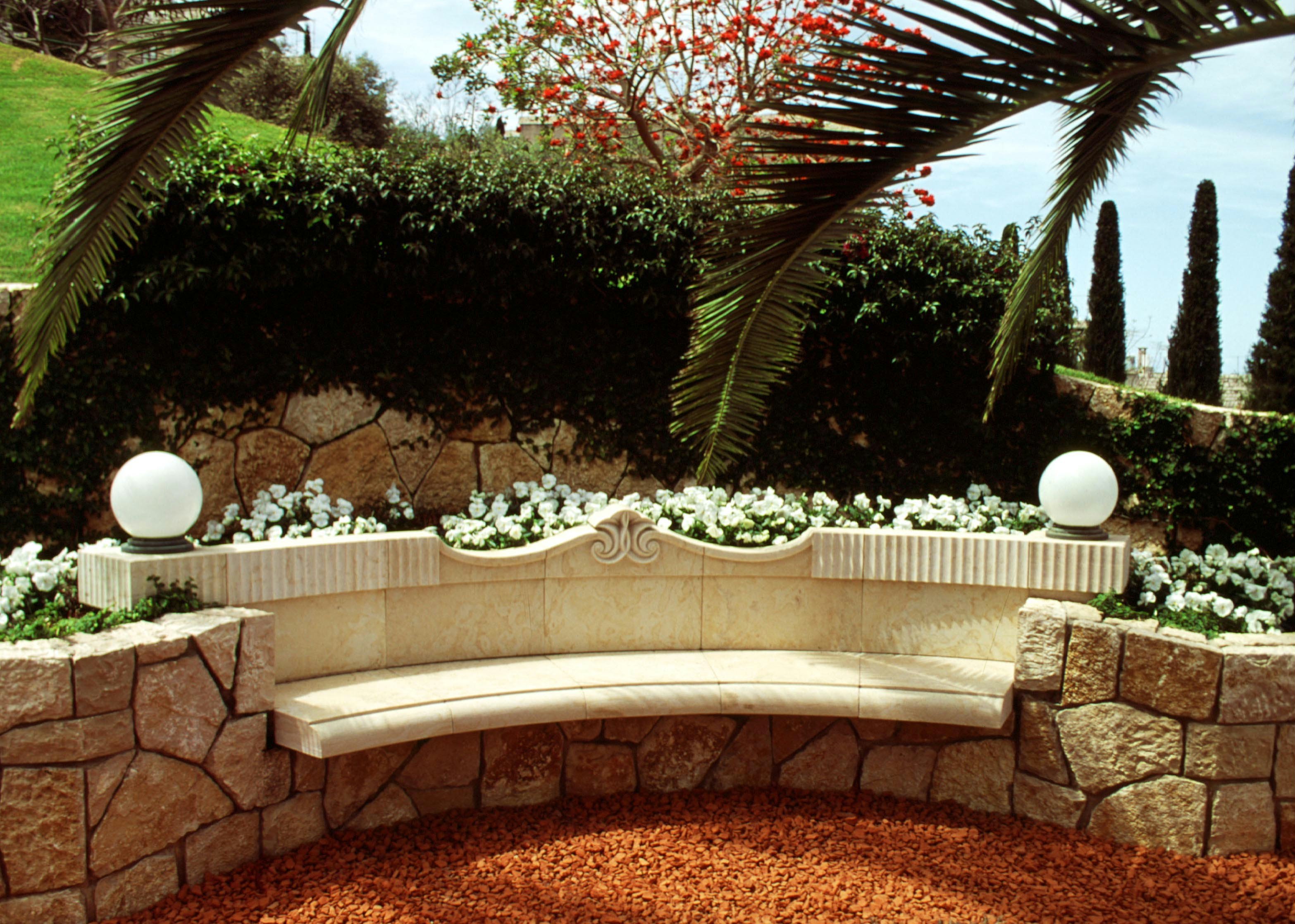 Flowers adorn a bench on a terrace.