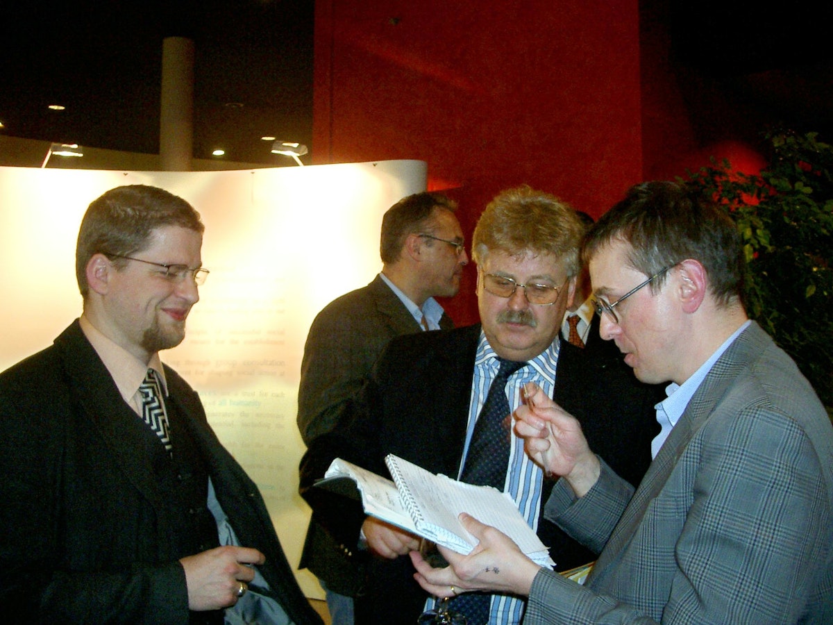 Elmar Brok (center), a German member of the European Parliament and Baha'i representative Peter Amsler (left) with another attendant at the exhibition's opening.