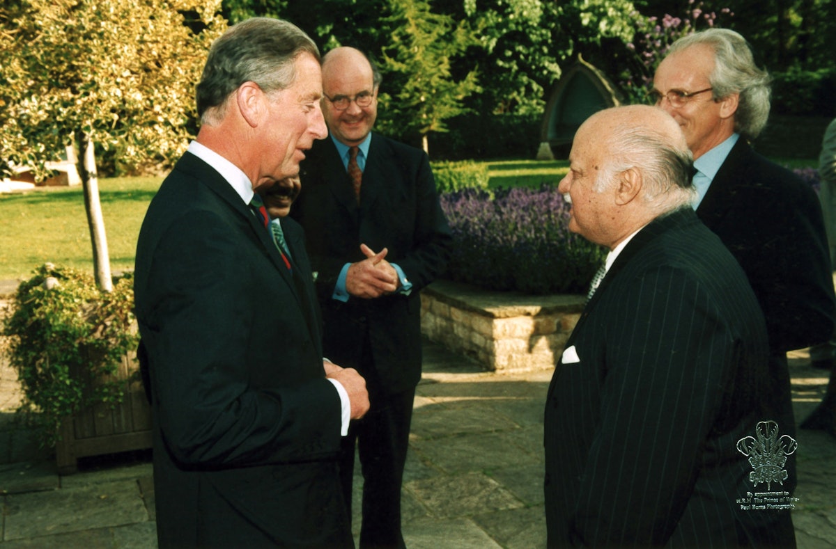 The Prince of Wales (left) with Professor Bushrui (foreground, right), at Highgrove, the Prince's estate, July 2002, on the occasion of a Temenos Academy function. In the background are Nicholas Parson (left) and David Cadman, both of the Temenos Academy. Photo by Paul Burns Photography.