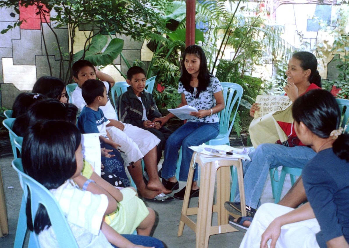 Children learning a Baha'i song from choir members.