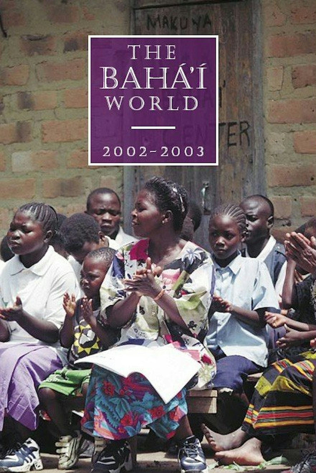 The cover of "The Baha'i World 2002-2003" features Baha'is in Ntambo, Zambia, singing at a devotional gathering.