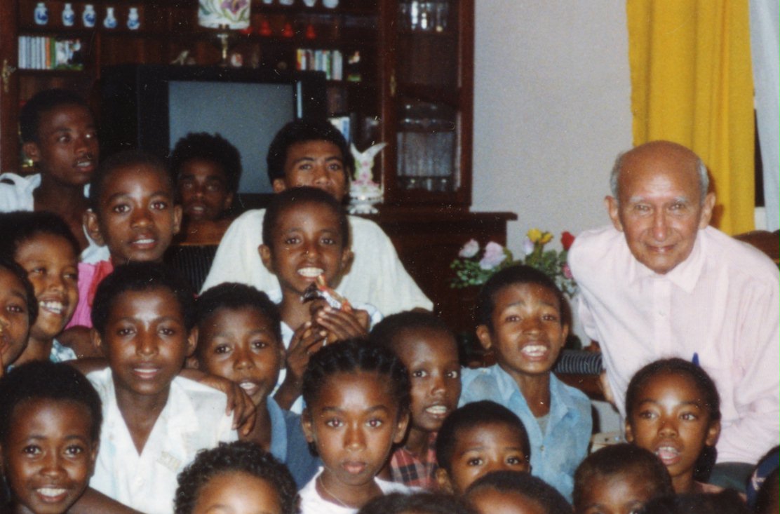 Baha'i children of Farafangana at the Naw-Ruz (New Year) celebration, 1991, with (at right) Gilbert Robert.