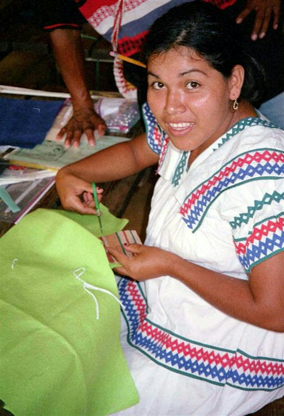 Teacher trainee Lineth Montezuma making fabric squares.