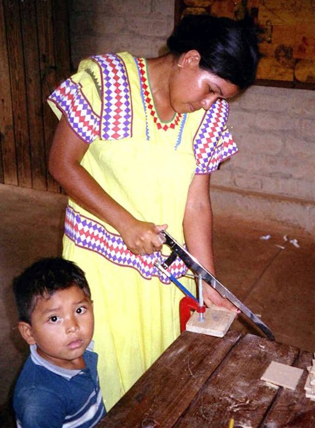 Teacher trainee Lineth Montezuma making items to assist in teaching mathematics.