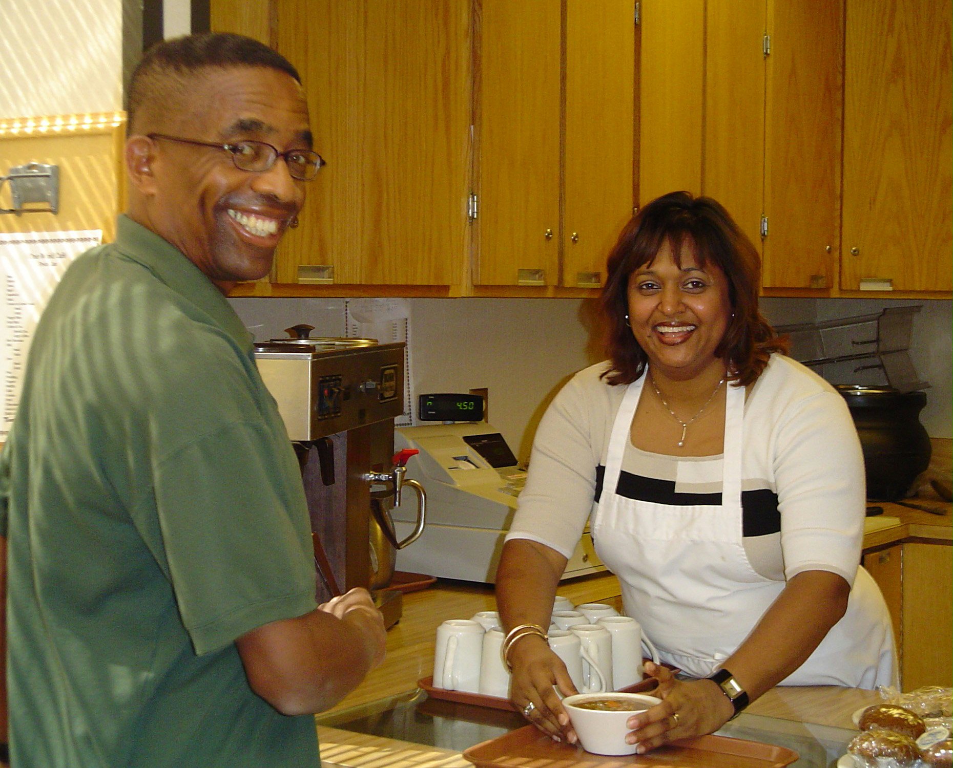 Customer John Headly receiving his order from Diana Gray.