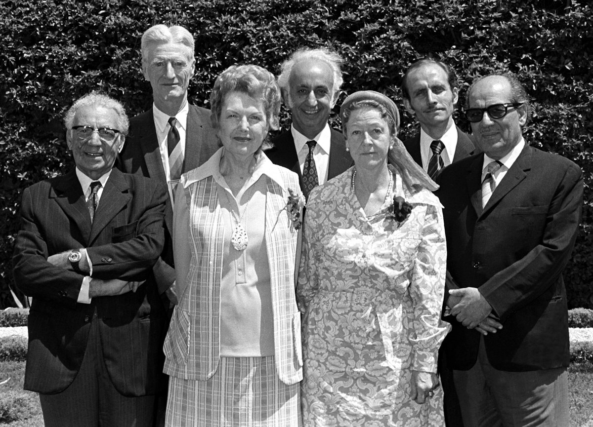 The Hands of the Cause with Counsellors of the International Teaching Centre, 1973: (front row, left to right) Mr. Ali-Akbar Furutan, Mrs. Florence Mayberry, Madame Ruhiyyih Rabbani, Mr. Abul-Qasim Faizi, (back row, left to right) Mr. Paul Haney, Mr. Aziz Yazdi, Mr. Hooper Dunbar.