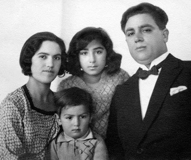 Gloria Faizi (center, rear) with her mother Najmieh (left), her father Rahmatu'llah Khan 'Ala'i (right), and her brother, Manuchihr.