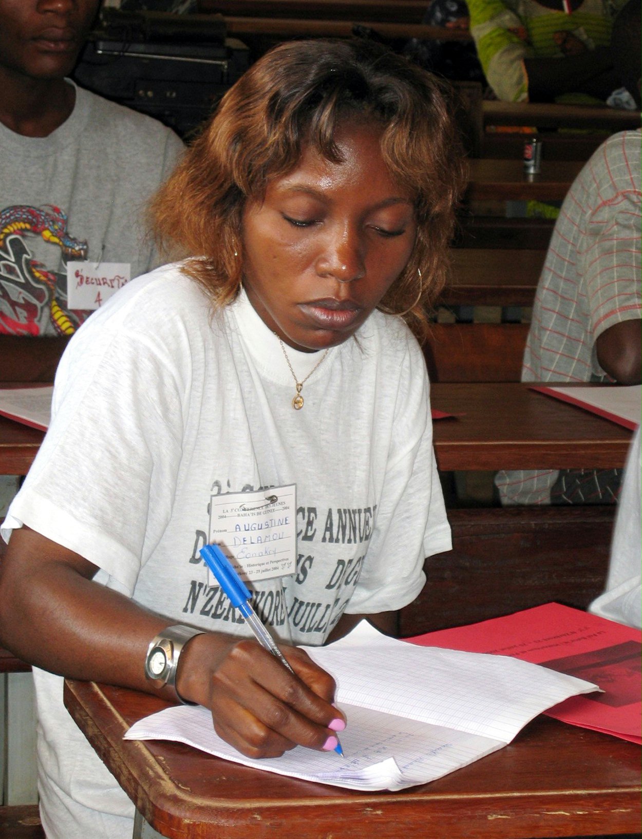 Augustine Doualamou, 26, a Baha'i from Conakry, takes notes during a presentation on the lives of the Central Figures of the Baha'i Faith.