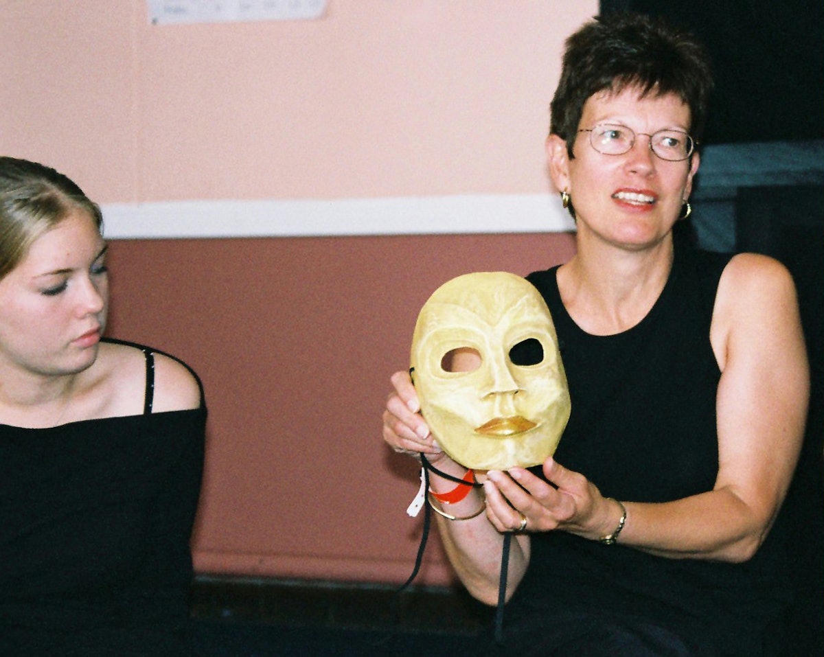 Alison Scrutton (right) displays a mask she used in a performance.