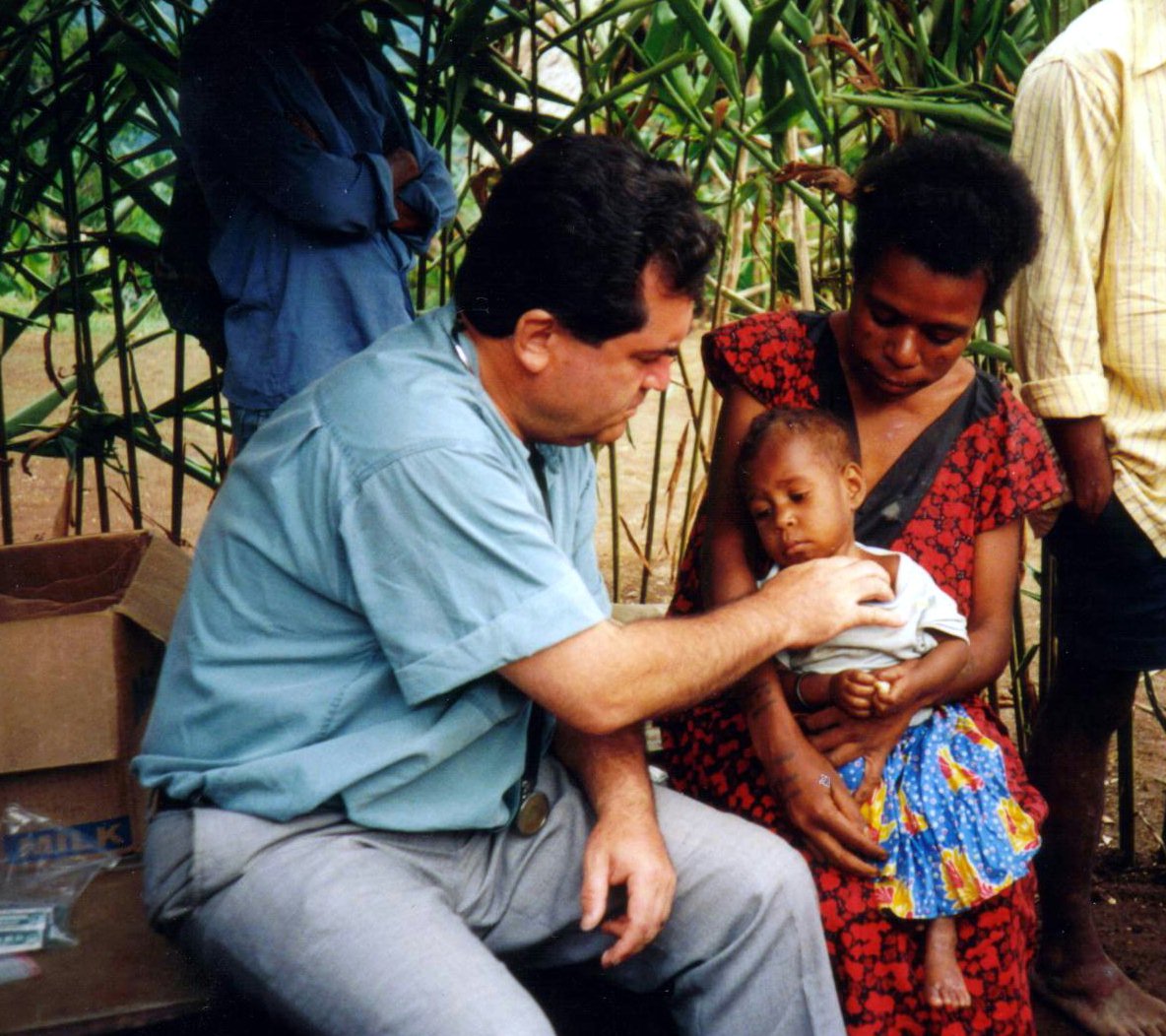 Professor Naraqi providing medical care in a remote village in Papua New Guinea.