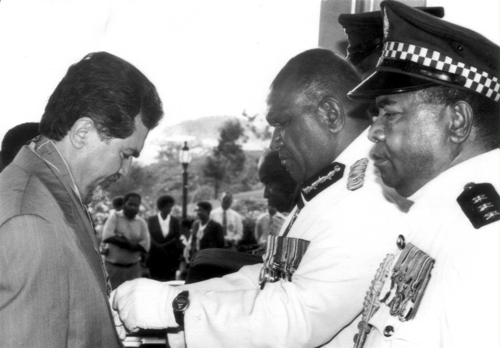 Sirus Naraqi receiving the CBE from the Governor General of Papua New Guinea, Sir Silas Atopare, Port Moresby, 1999.