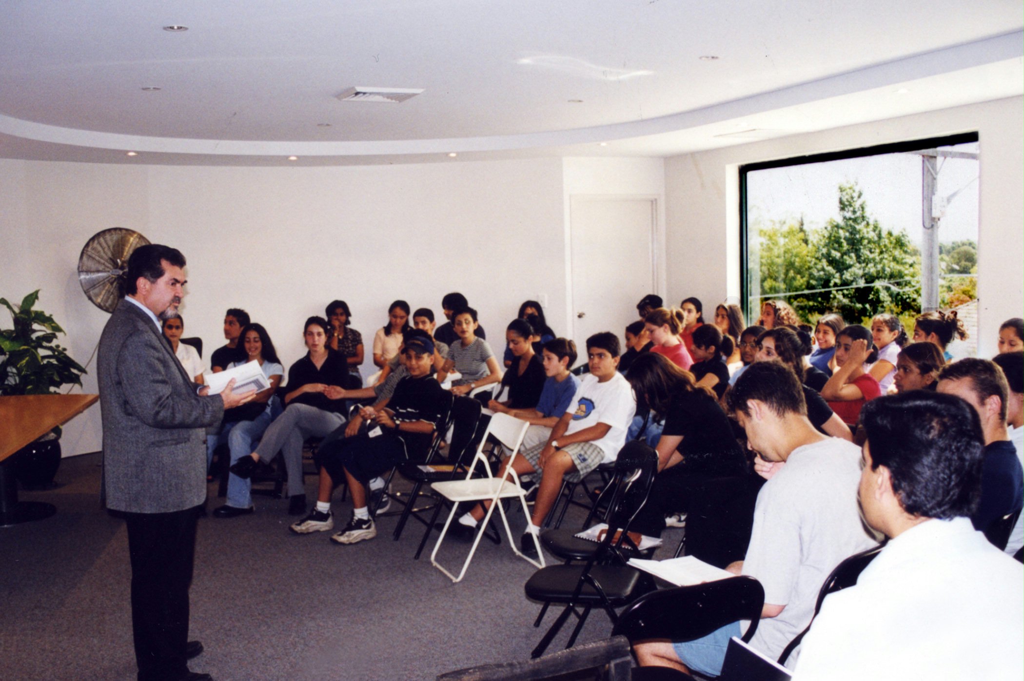 Professor Naraqi leading a Baha'i youth class in Sydney, Australia, 1999.