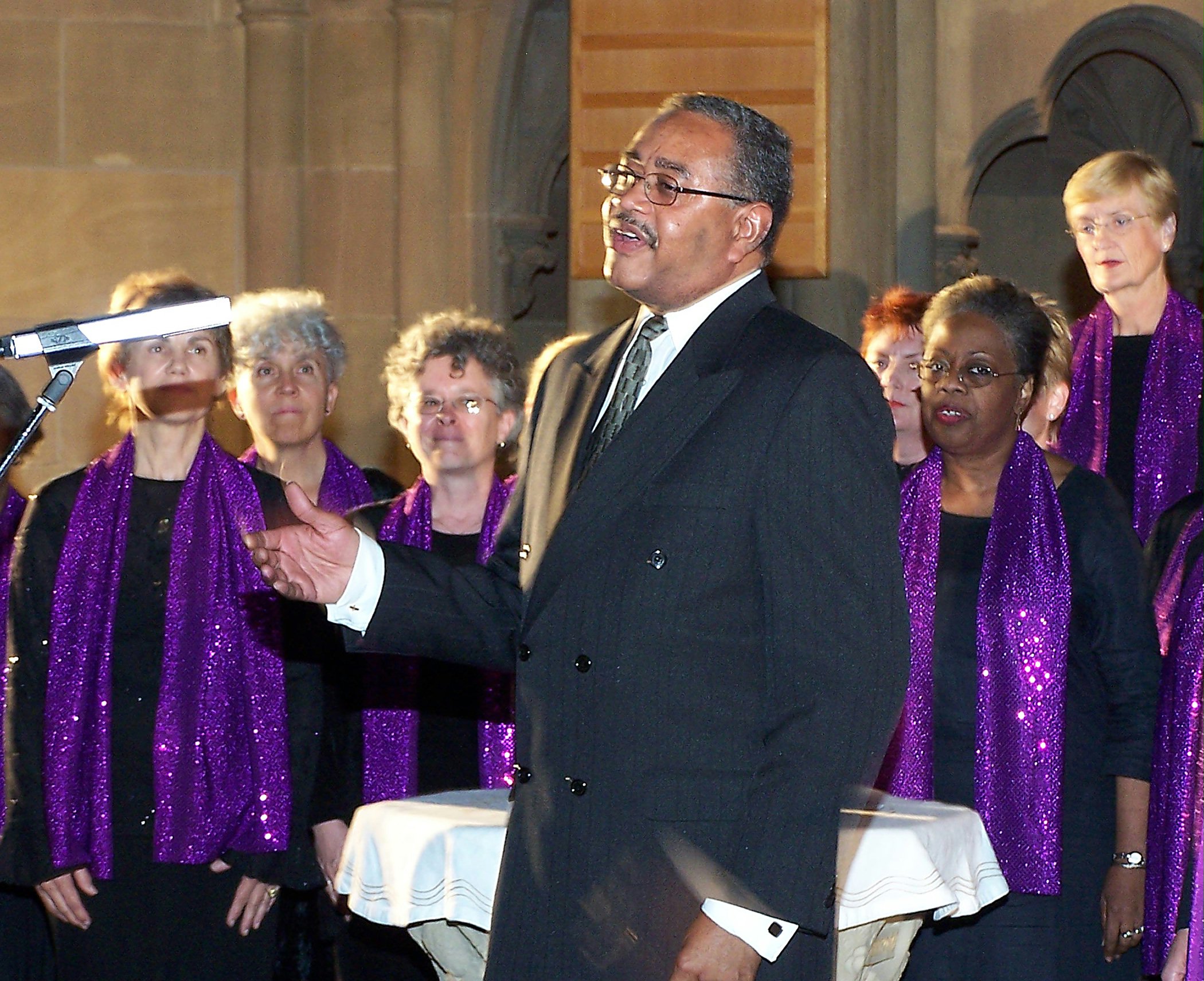 Director, Van Gilmer, singing with members of the Baha'i Gospel Choir.