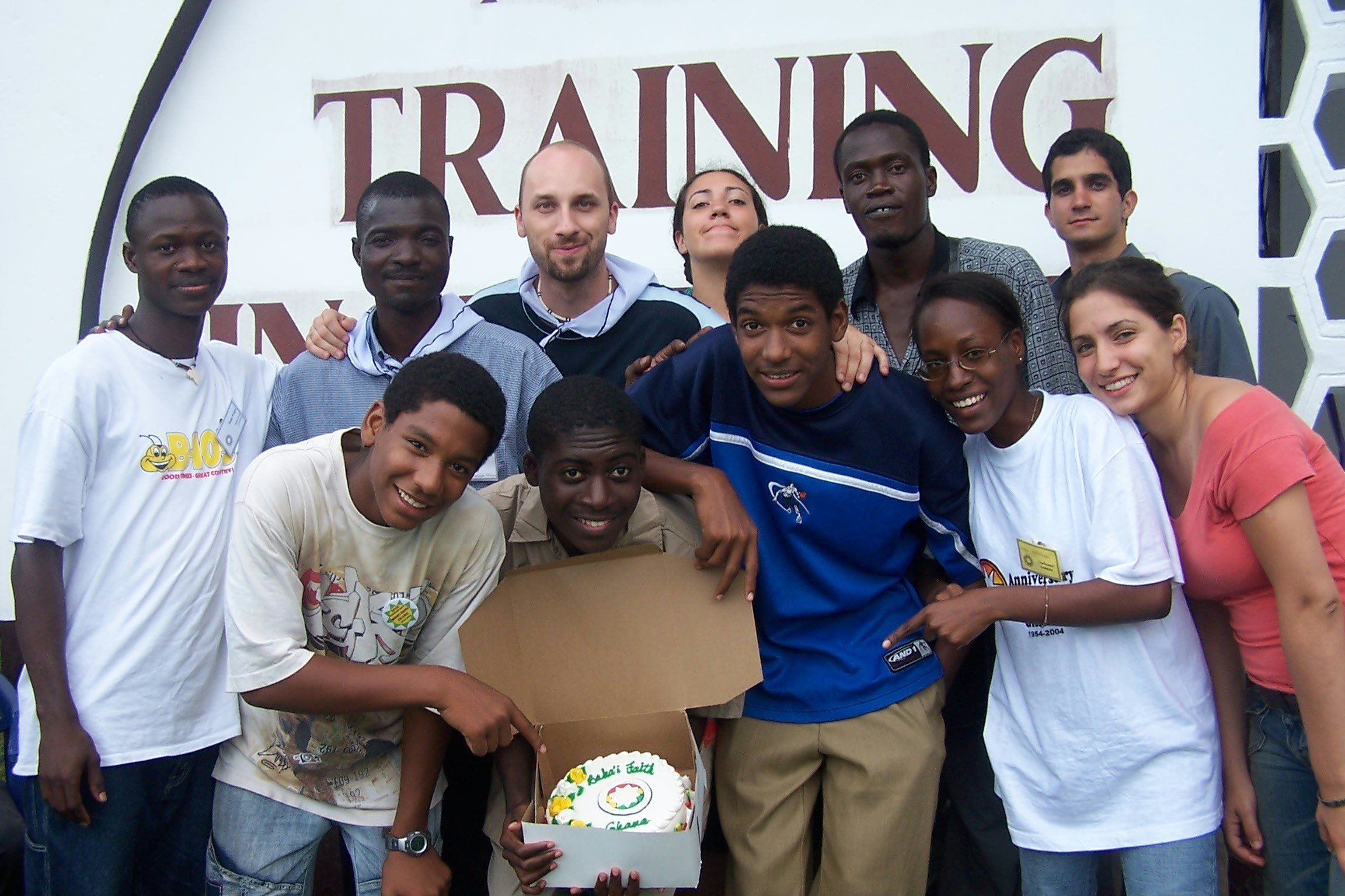 Baha'i youth from Canada, Burkina Faso, Guinea, Togo, and the United States with a jubilee cake. Photo by Yoofi Nketsiah.