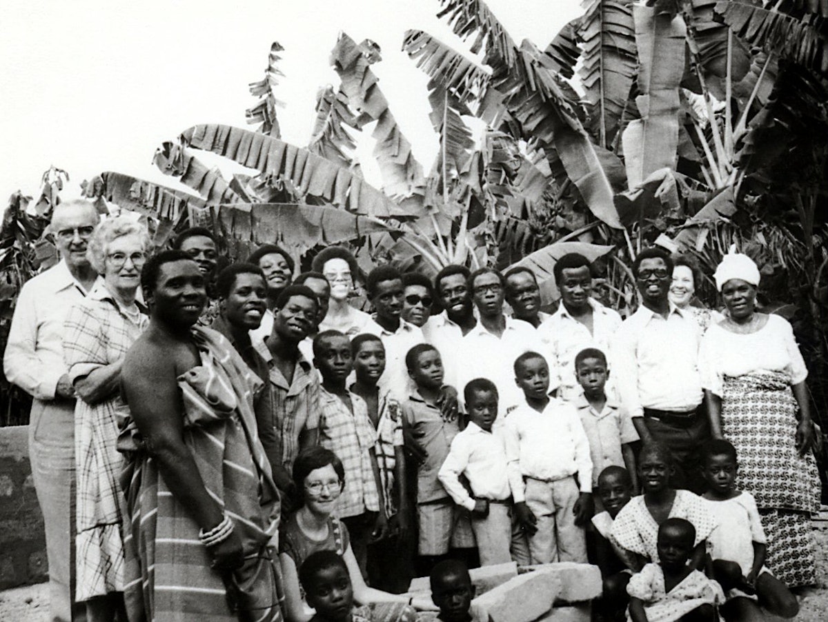 Hand of the Cause Collis Featherstone (extreme left) and Mrs. Featherstone with Baha'is in Ghana, 1979.