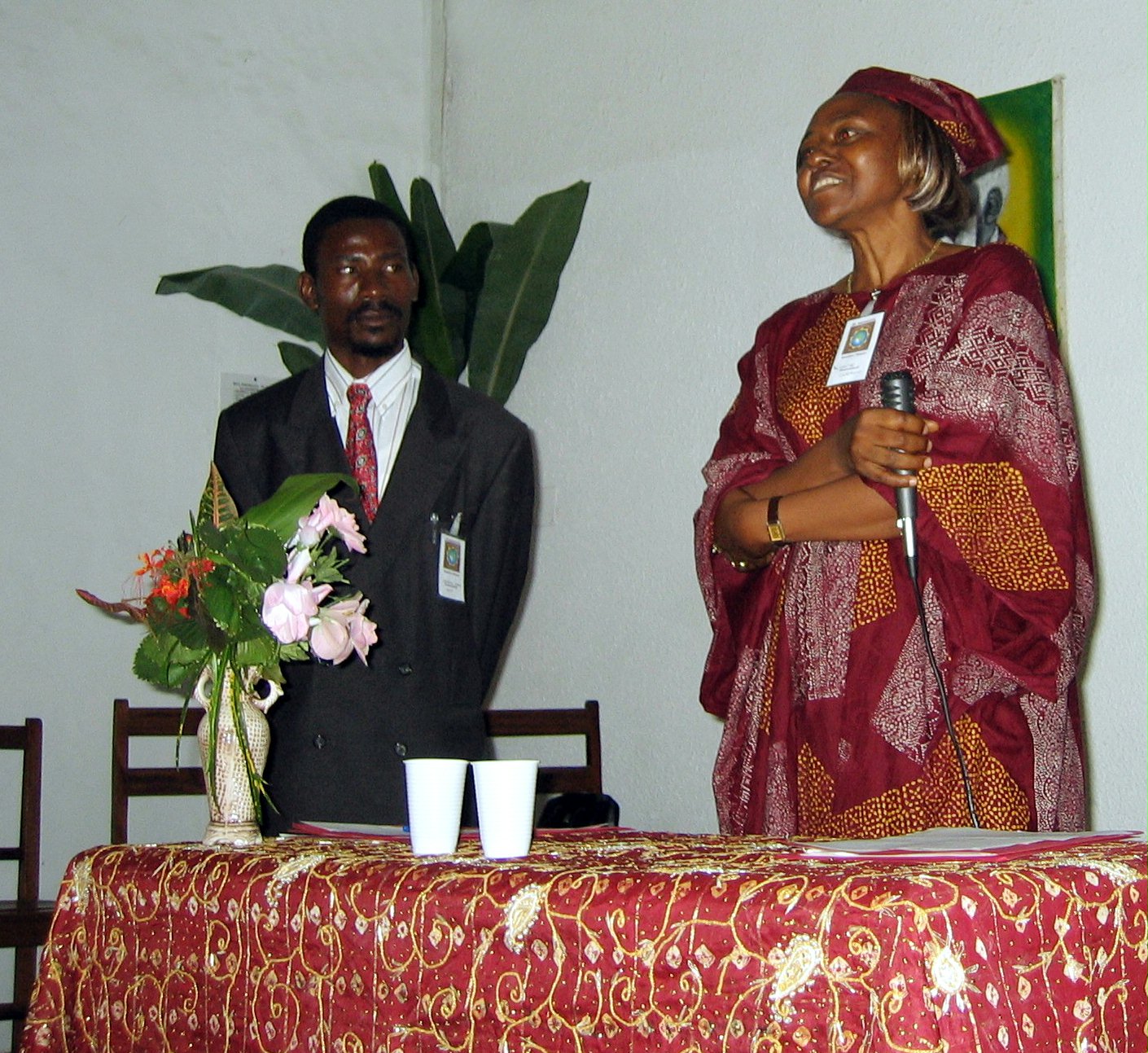 Christine Tchameni addressing the participants. At left is the master of ceremonies, Valeriano Ebang.