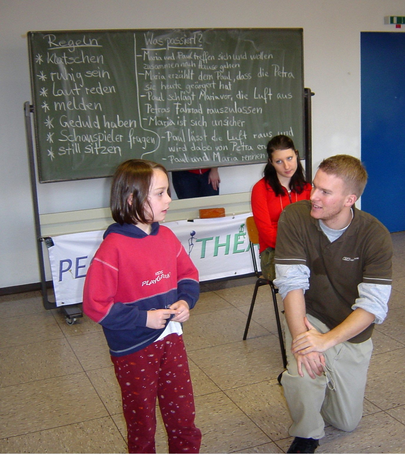 People's Theater in action. Elements of the scene are outlined on blackboard.