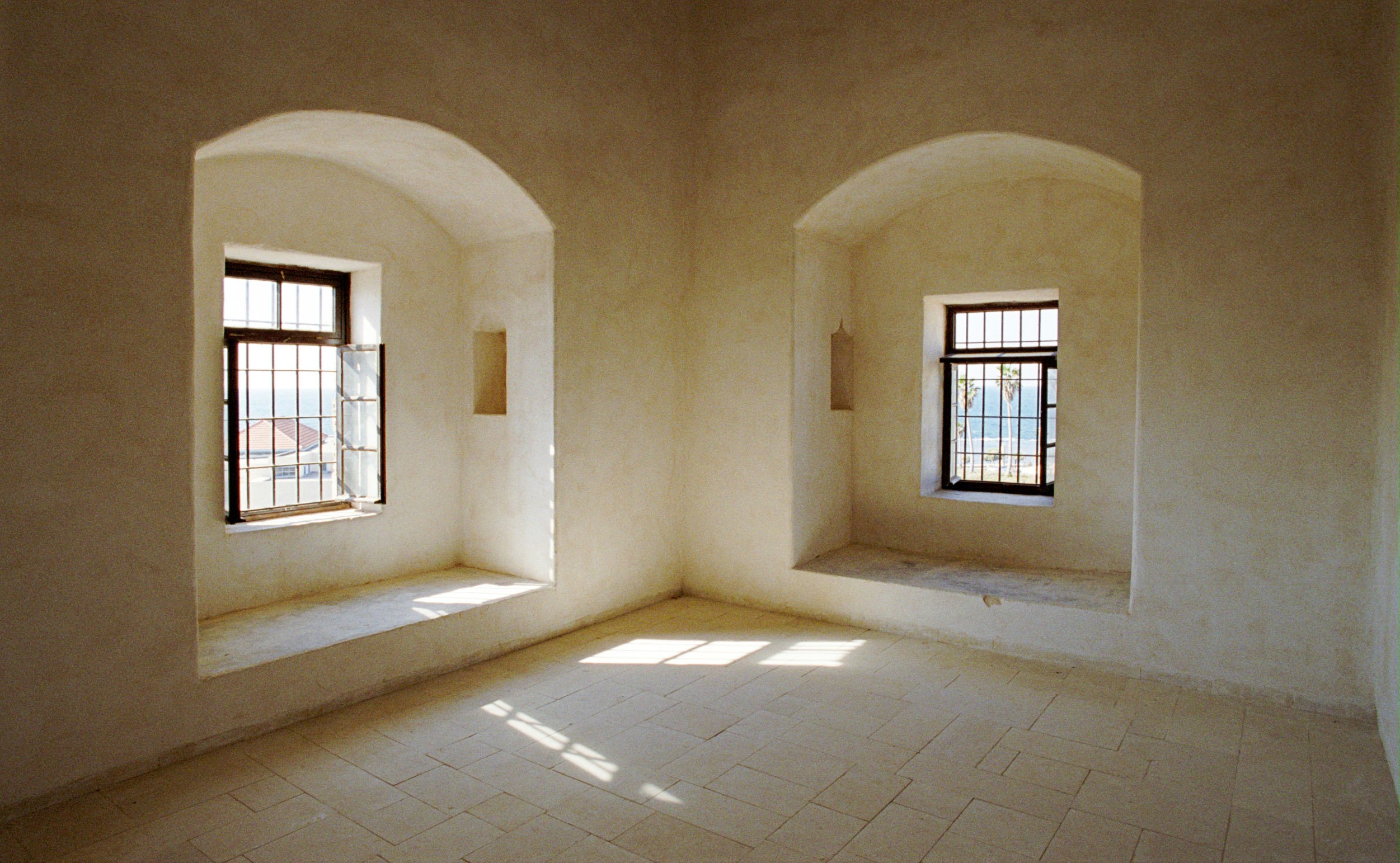 A restored room near the cell of Baha'u'llah, Who waved to pilgrims from the window at right. (2004)