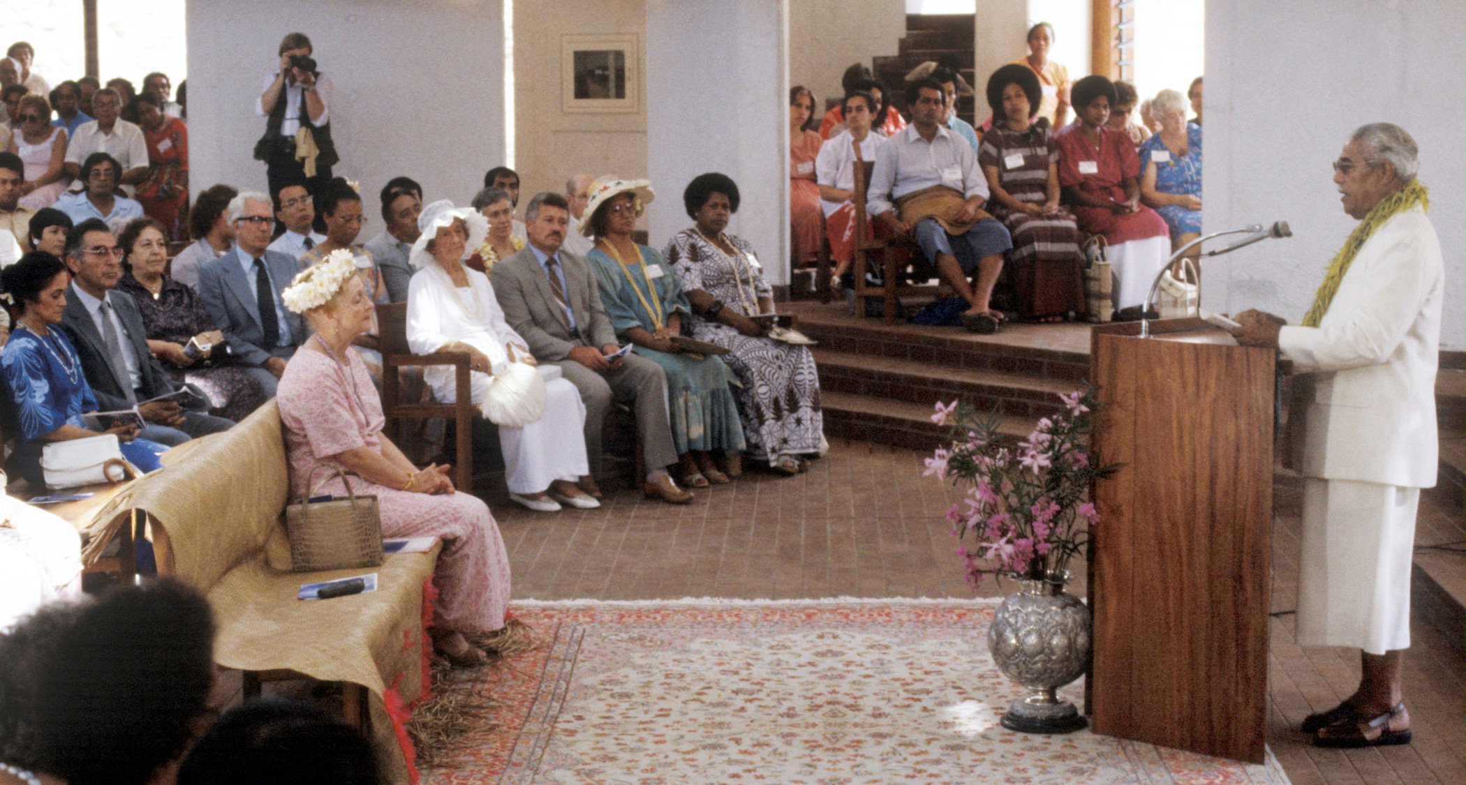 Madame Ruhiyyih Rabbani (front row, left), a Hand of the Cause of God, listening to an address by the Head of State of Samoa, His Highness Susuga Malietoa Tanumafili II, in the Baha'i Temple during the dedication ceremony, 1984.