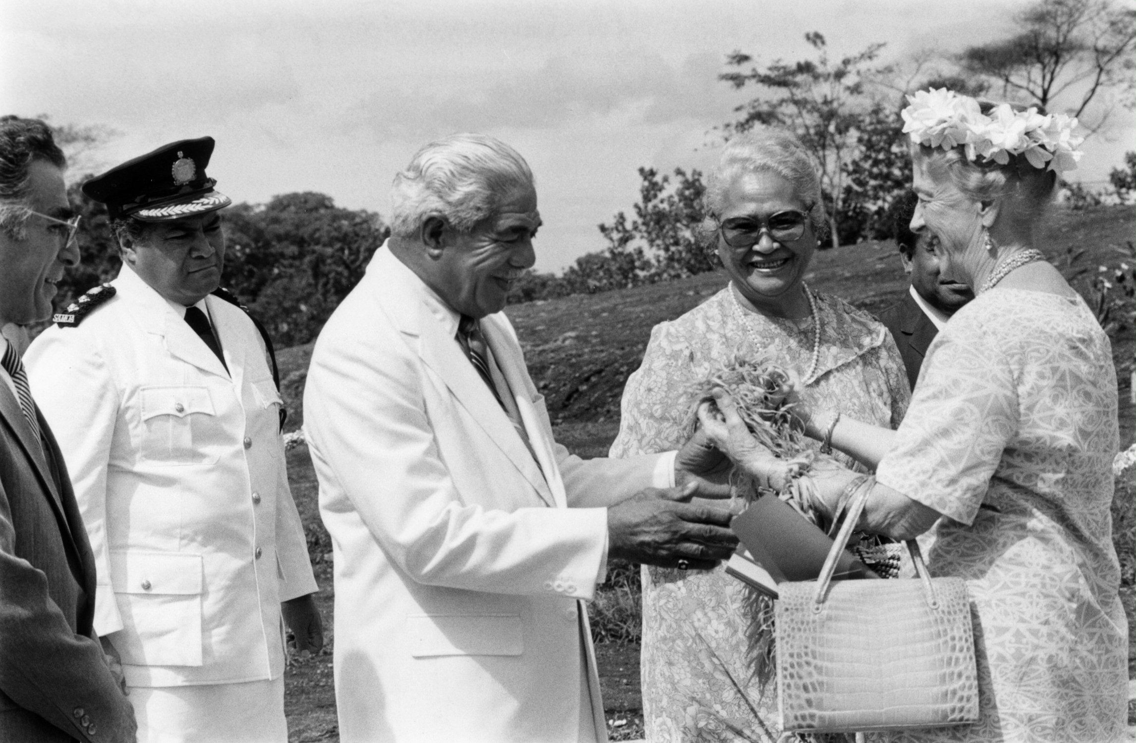 Madame Ruhiyyih Rabbani, a Hand of the Cause of God, (right) is greeted by the Head of State of Samoa, His Highness Susuga Malietoa Tanumafili II, and his wife, Masiofo Lili Tuni Malietoa, at the dedication of the Samoan Temple, 1984. At far left is Suhayl Ala'i, a member of the Continental Board of Counsellors.