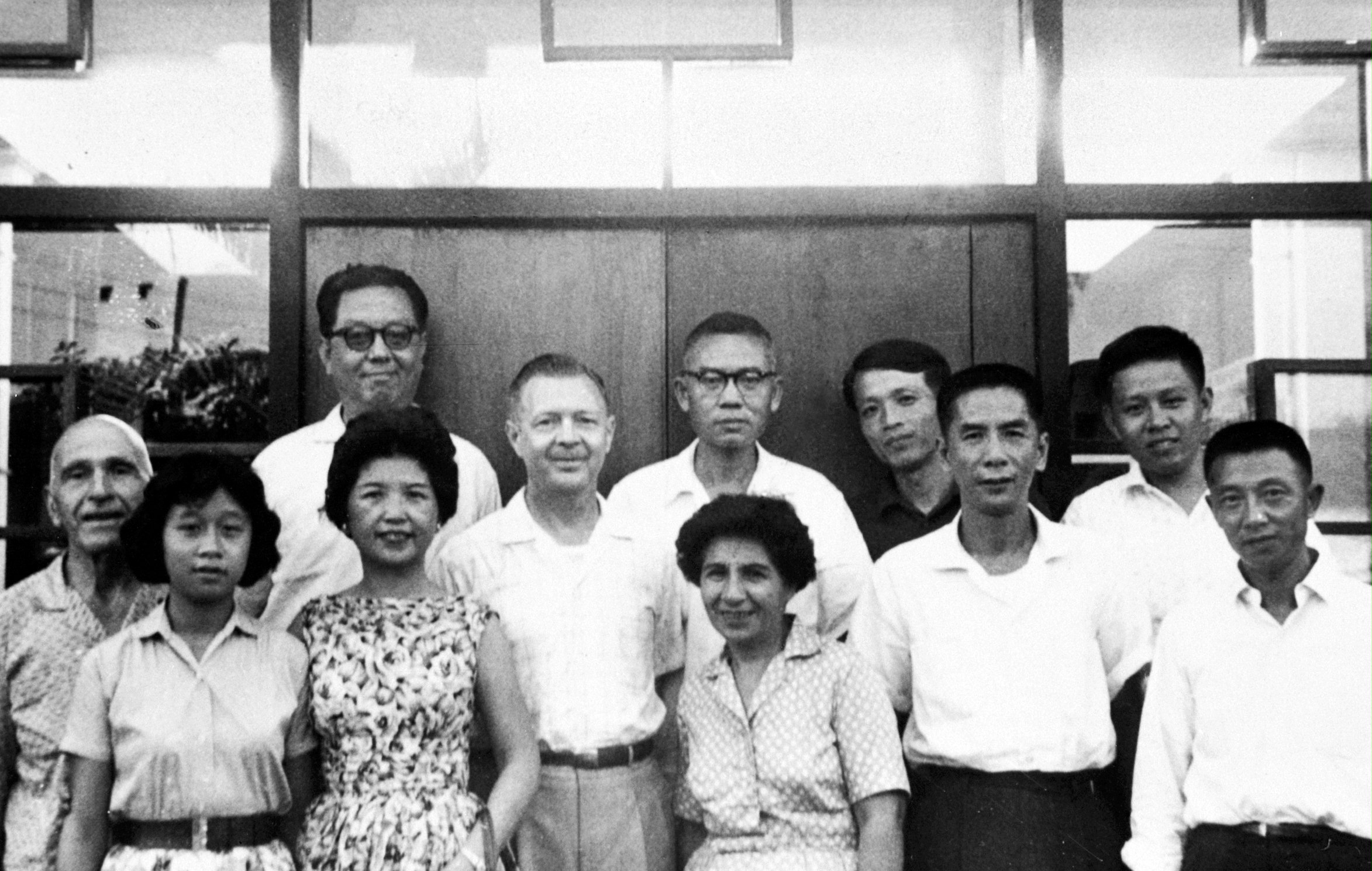 Early members of the Taiwanese Baha'i community, Mr. Suleimani (left) and Mrs. Suleimani (center, front) with participants at a summer school on the island, 1961.