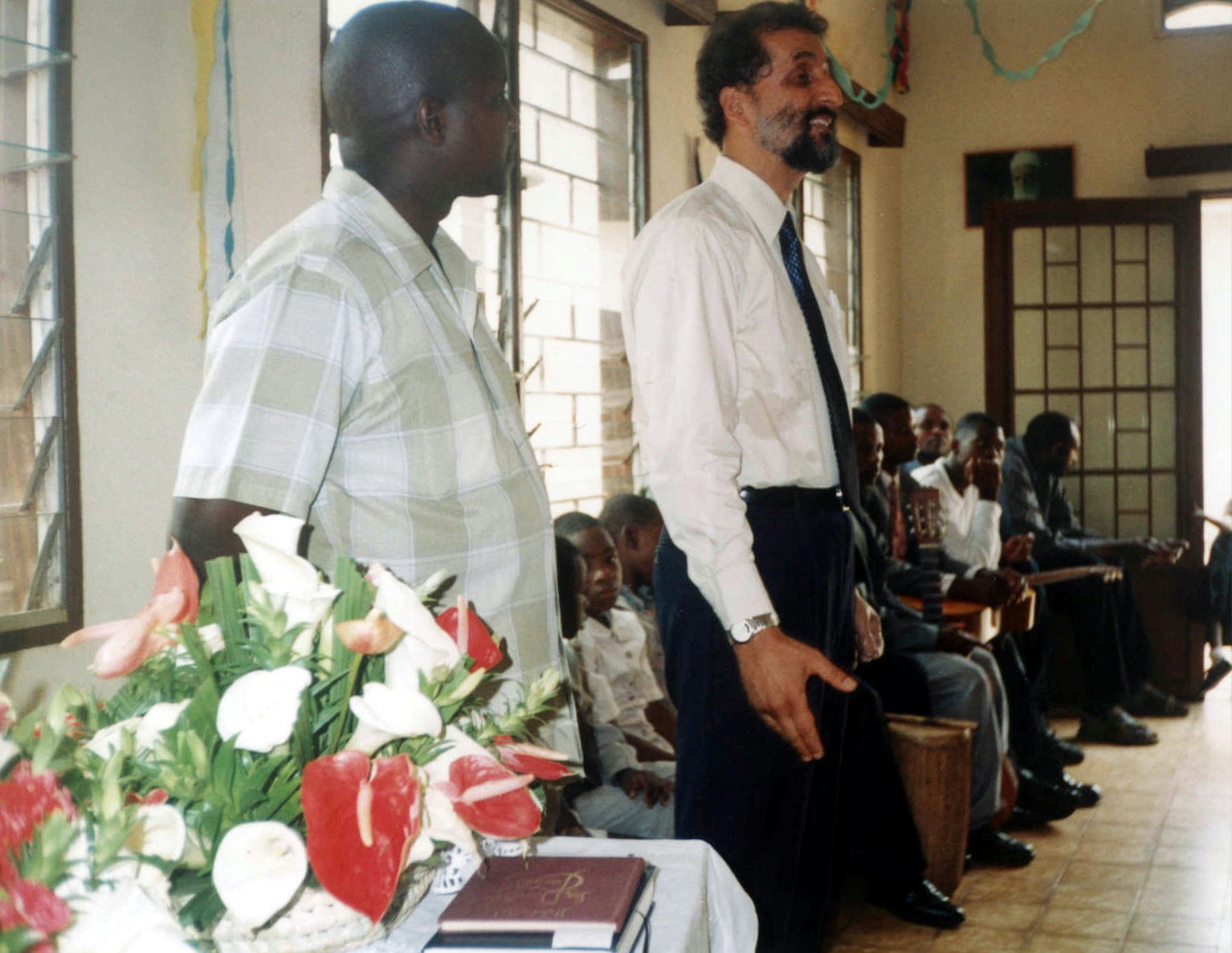 The role that the Burundi Baha'i community has played in the country was the topic of an address by a member of the Continental Board of Counsellors in Africa, Ahmad Parsa (standing right), at the community's golden jubilee celebrations.