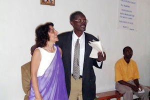 Higiro Anastase, a brother of the first Bahá'í of Rwanda, Alphonse Semanyenzi, speaking at the Rwandan jubilee celebrations about historical events. Mr. Anastase is a member of the National Spiritual Assembly of the Baha'is of Rwanda, as is Hayede Parsa (left.