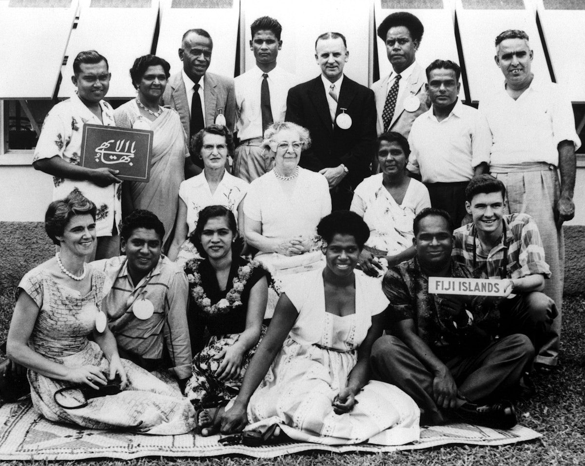 Participants in the first regional convention of the Baha'is of the South Pacific, Suva, Fiji, 1959. Hand of the Cause of God Collis Featherstone is at rear, fifth from left. A member of the Continental Board of Counsellors Tinai Hancock, of Fiji, seated in the front row, fourth from left. Irene Jackson (later Mrs. Williams) is at front row, left.