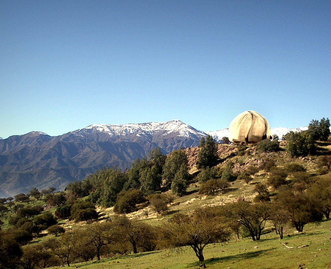 A model of the Baha'i House of Worship for South America superimposed on a photograph of the site north of Santiago, Chile.