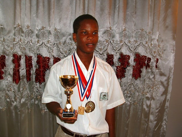 Champion junior weightlifter Christopher Clarke with some of his awards.