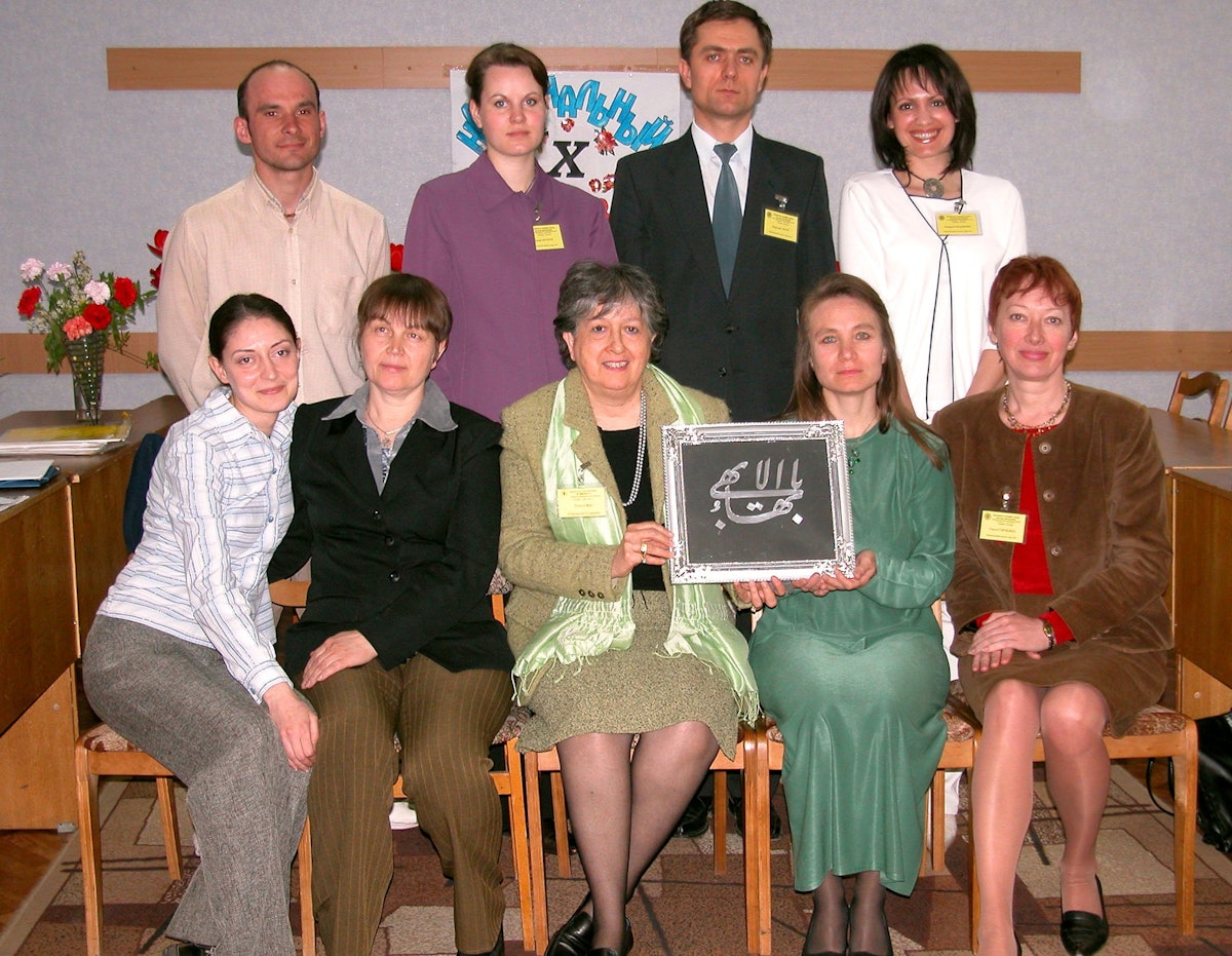 Eight of the nine members of the National Spiritual Assembly of the Baha'is of Moldova elected in 2005. At centre, front, is a member of the Continental Board of Counsellors in Europe, Fevziye Baki, who is helping display a calligraphic form of "the Greatest Name," a reference to Baha'u'llah.